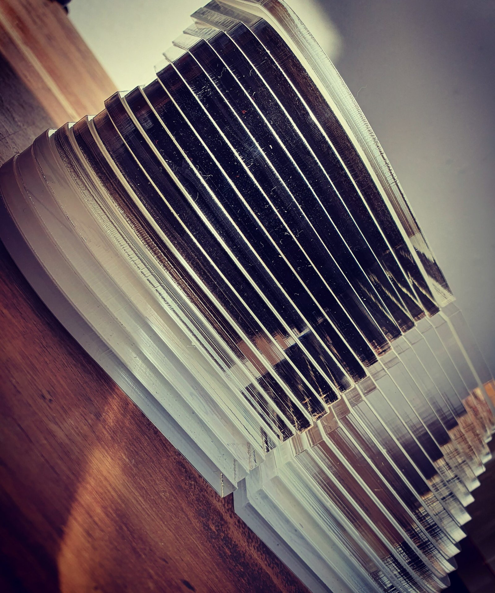 Stacked laser cut acrylic parts showing polished edges and precision machining