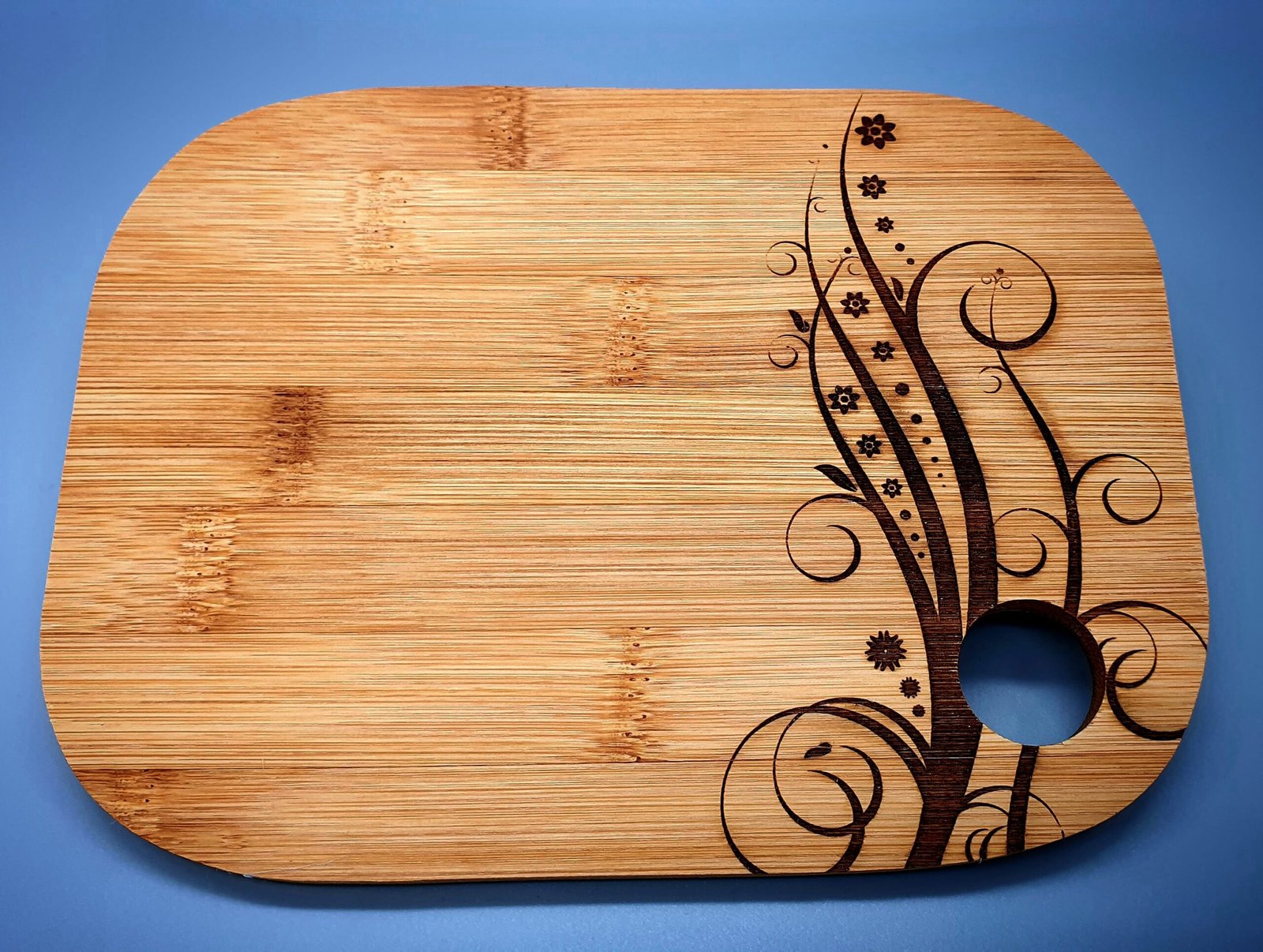 Laser engraved bamboo serving board with floral decorative design