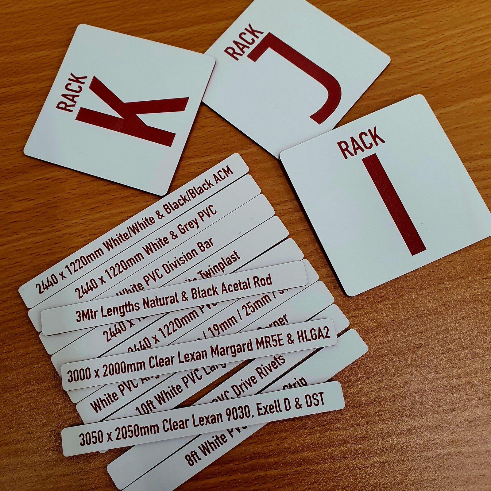 Laser engraved plastic material labels and rack markers used for identifying sheet stock