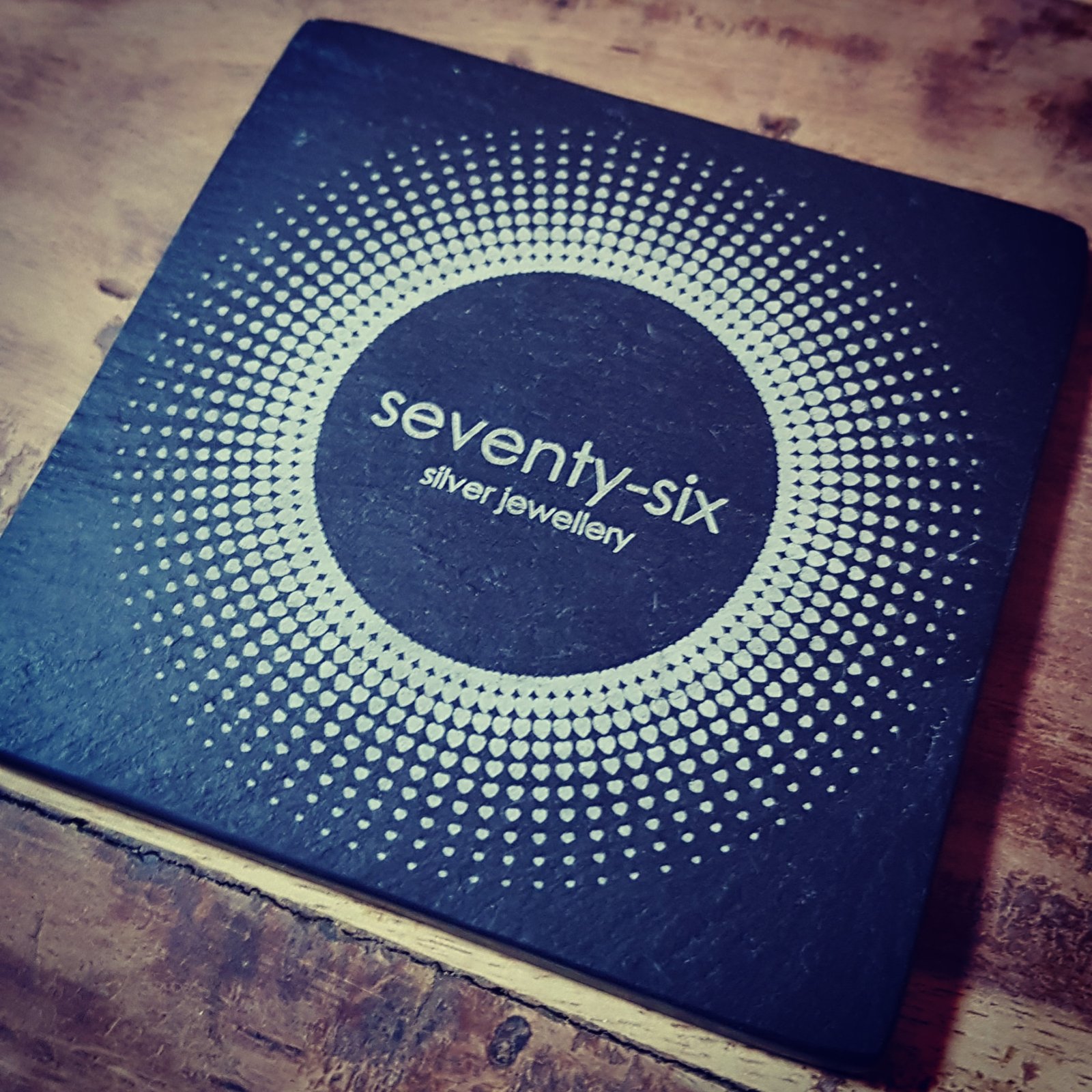 Laser engraved slate coaster with circular pattern and Seventy-Six Silver Jewellery branding