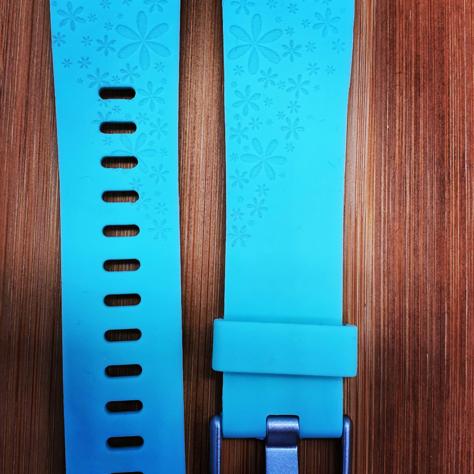 Silicone watch strap engraved with a subtle repeating floral pattern